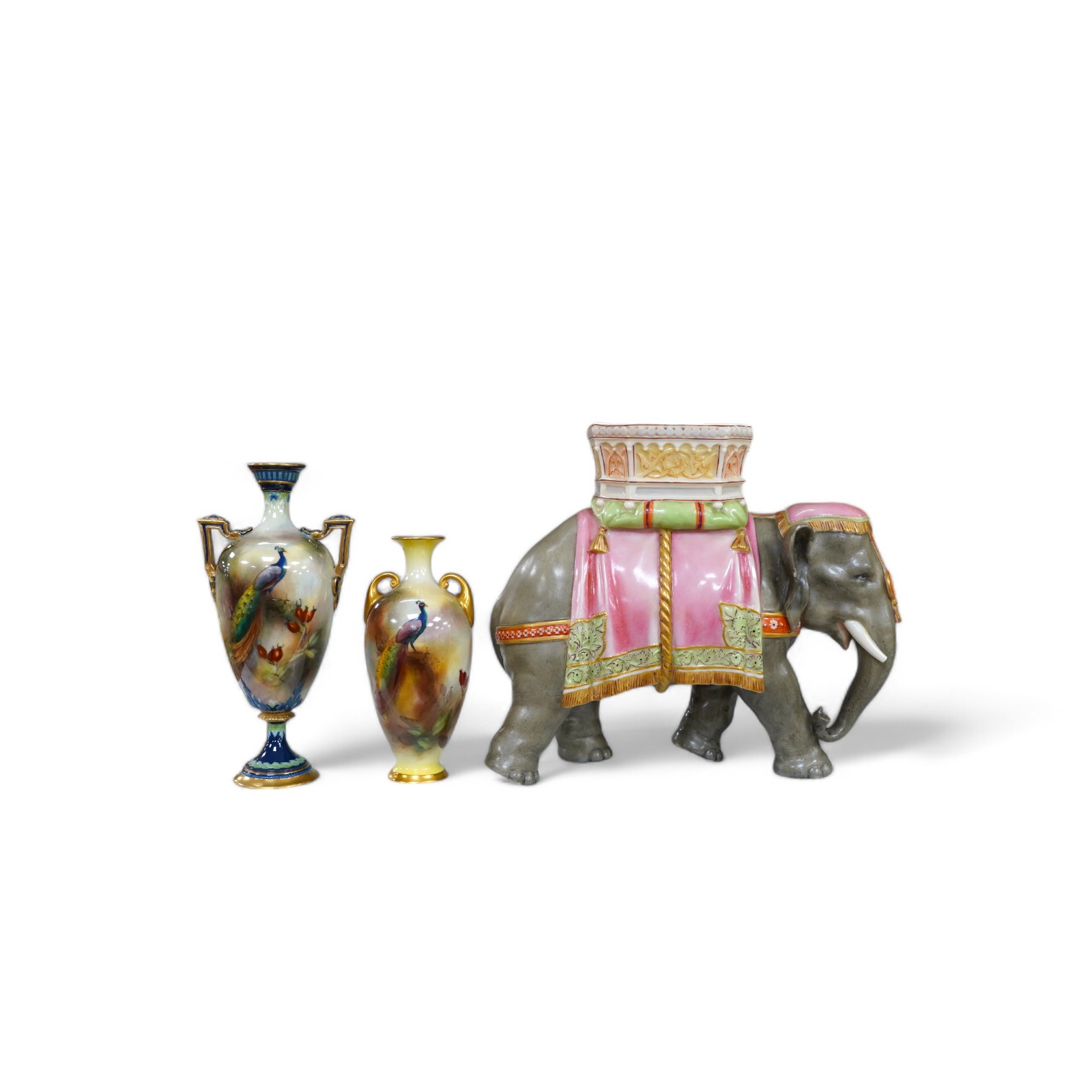 A Hadley's Worcester elephant with howdah and two Hadleys vases, peacock decoration, tallest 19.5cm. Condition - good